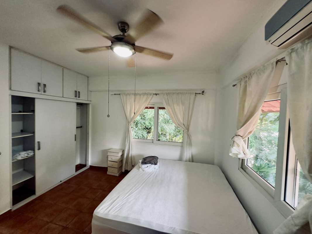 Covered terrace with wooden ceiling fans garden view Ciudad del Saber Clayton house for rent