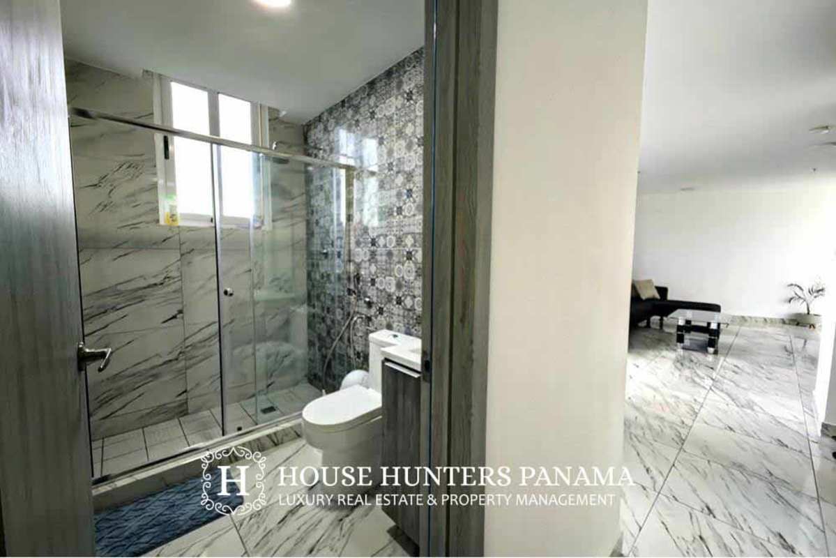 Contemporary bathroom with tile and glass shower in The Sands Panama apartment