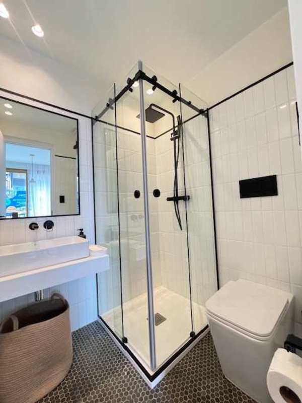 Bedroom with sliding door to balcony, wood accent wall in PH NOOK Bella Vista Panama