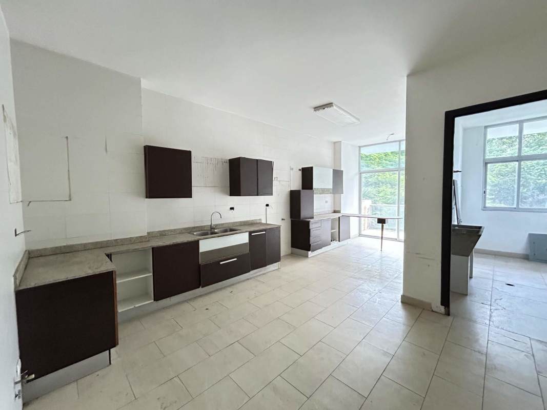Contemporary kitchen with ample cabinetry and large windows in apartment at PH The Bridge Amador Panama City.