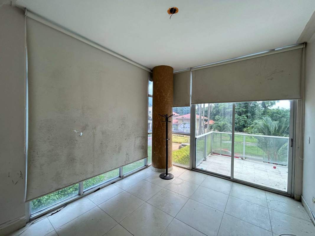 Spacious bedroom with large window and built-in wardrobe in The Bridge Amador Panama.