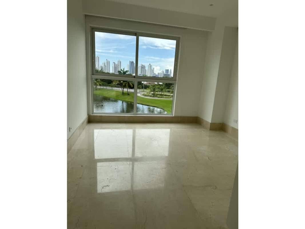 Santa Maria golf course and lake view with Panama City skyline at sunset from The Reserve condo