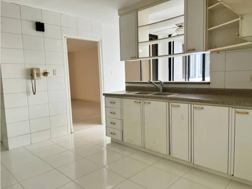 Minimalist kitchen with granite counters, white cabinetry PH Terrazas del Cangrejo Panama