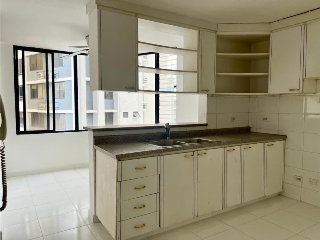 Spacious kitchen with granite countertop, white cabinetry and natural lighting El Cangrejo Panama