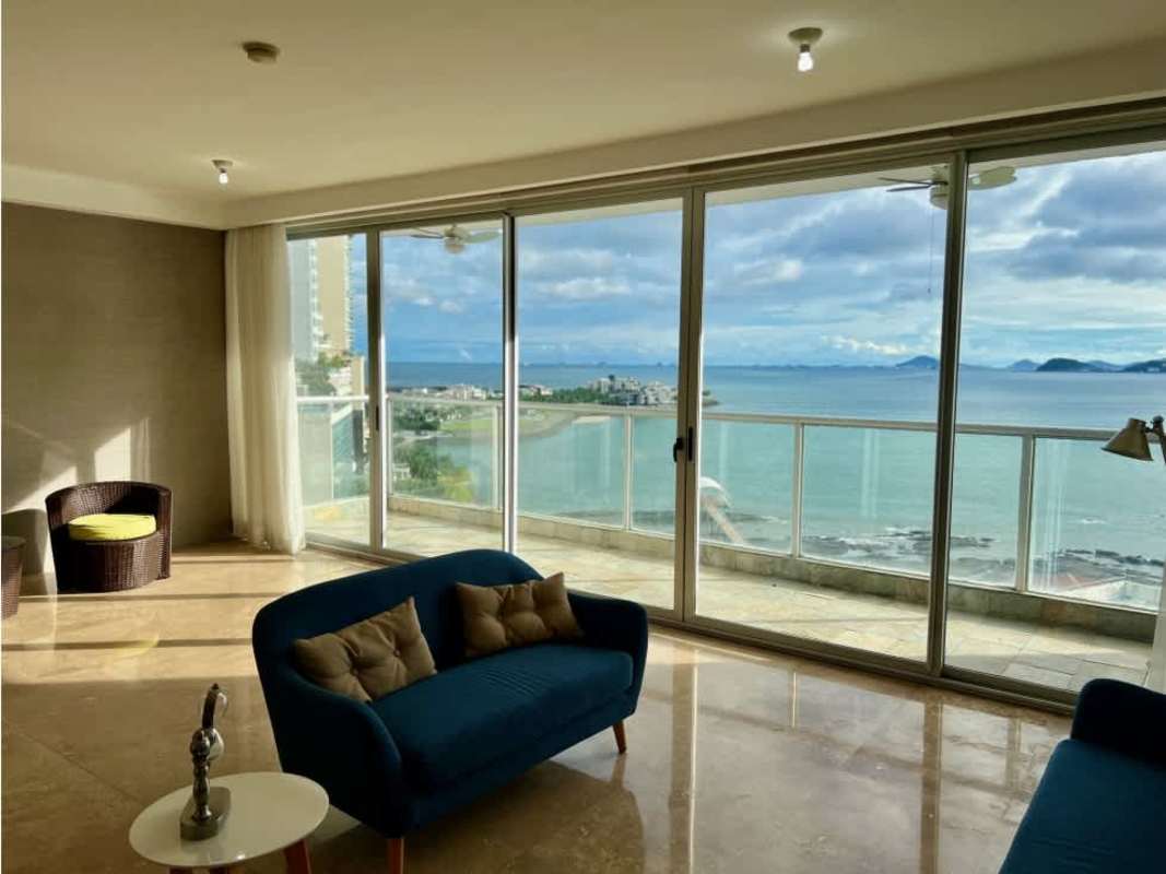 Modern living area with large glass, ocean view, marble floors Q Tower Panama