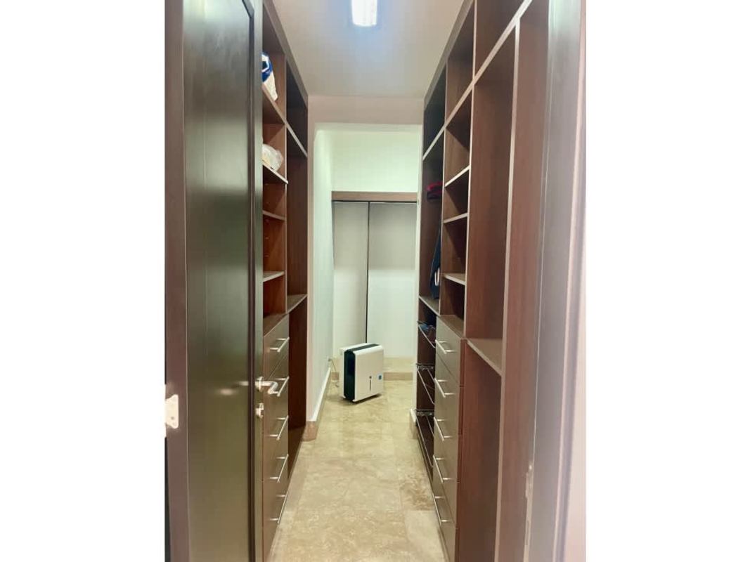 Spacious walk-in closet wood cabinetry tile marble flooring Q Tower Panama