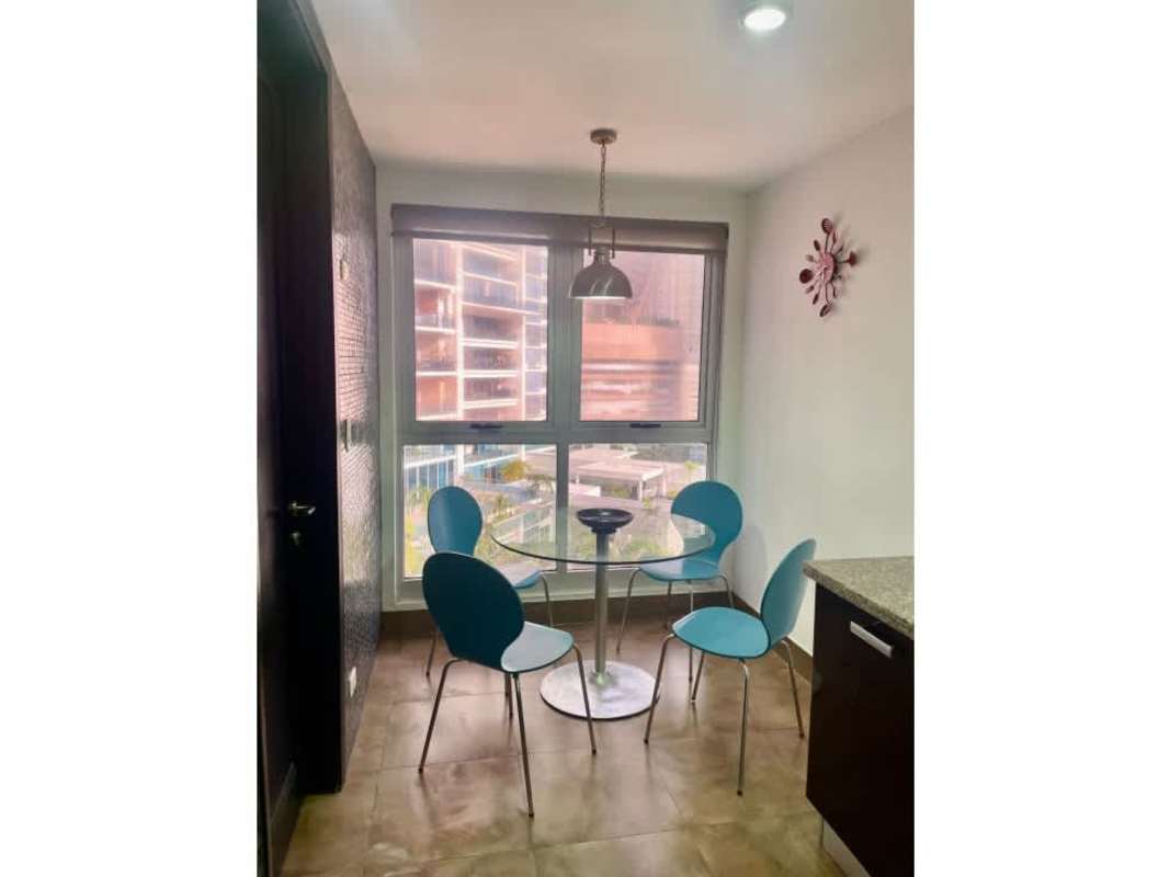 Dining area with glass table blue chairs overlooking ocean PH Q Tower Panama