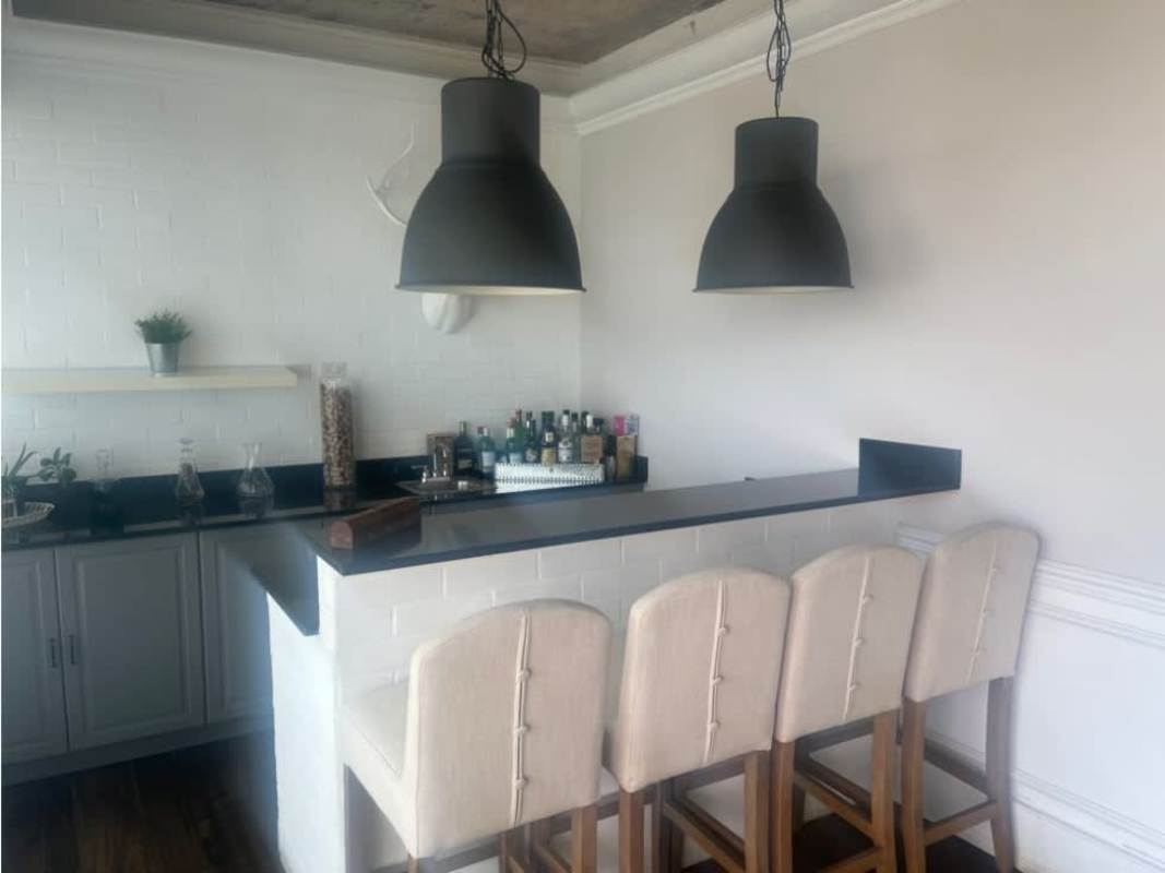 Modern kitchen with granite island and stainless appliances in PH Ocean Park Punta Pacifica