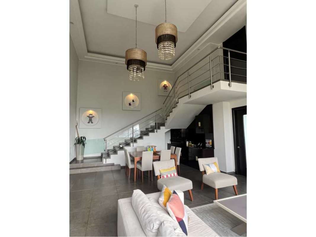 Dining area with decorative artworks and open loft in PH Portanova El Cangrejo Panama City apartment for sale