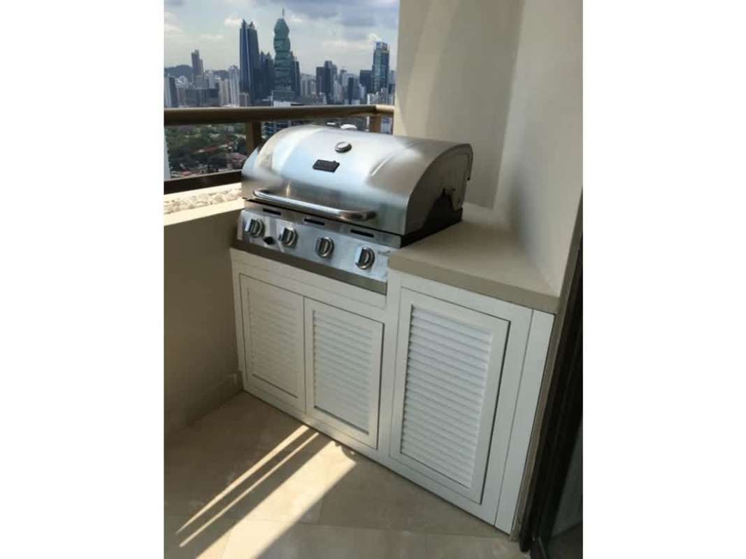 Large balcony with ocean view, built-in barbecue and outdoor seating in PH Ocean Park Panama City