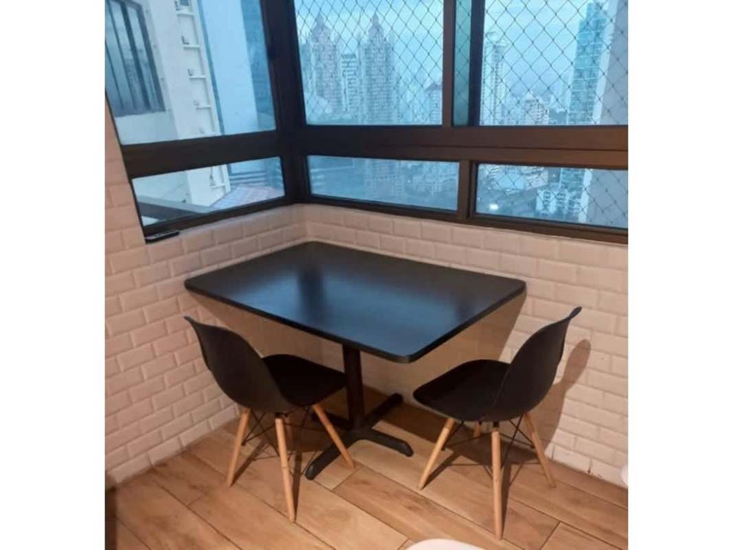 Dining area with city and ocean views, floor-to-ceiling windows in PH Ocean Park Panama City