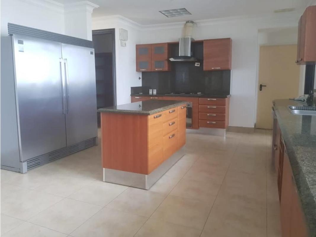 Spacious kitchen with granite countertops, island, stainless steel fridge & appliances PH Ten Tower Costa del Este