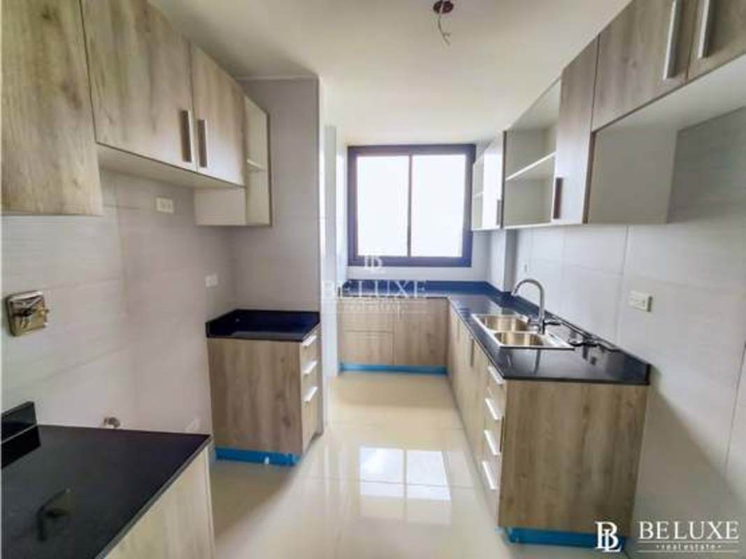 Contemporary kitchen with granite countertops, large window and cabinetry in PH Carreras Tower El Cangrejo