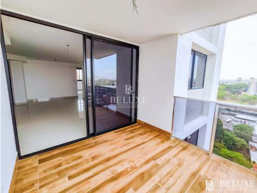 Modern balcony with glass railing and panoramic Panama City view at PH Carreras Tower