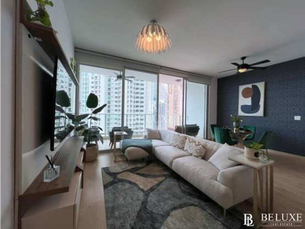 Bright open-plan living room with large windows and water views in PH Dupont Punta Pacifica