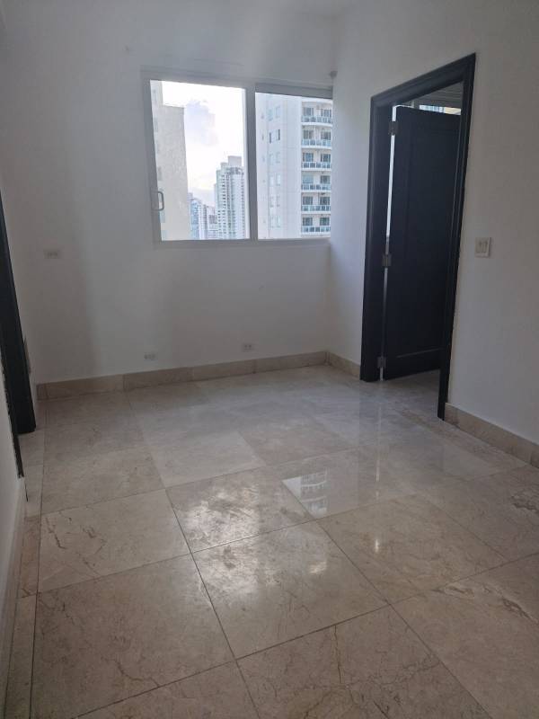 Spacious kitchen with granite, island, wood cabinets, and stainless appliances at PH Venetian Panama