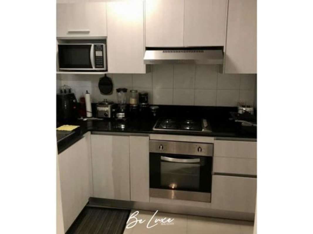 Stainless steel appliances and granite counters in PH Sky Level apartment kitchen Panama City