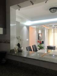 Open dining space view from kitchen with granite pass-through, decorative lighting, PH Silver City Colón Panama