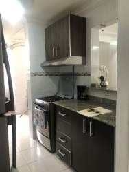 Kitchen with granite countertop, stainless appliances, dark cabinetry at PH Silver City Colón Panama
