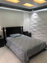 Enclosed balcony or sunroom with tiled floor and green wall feature in PH Silver City Colón Panama