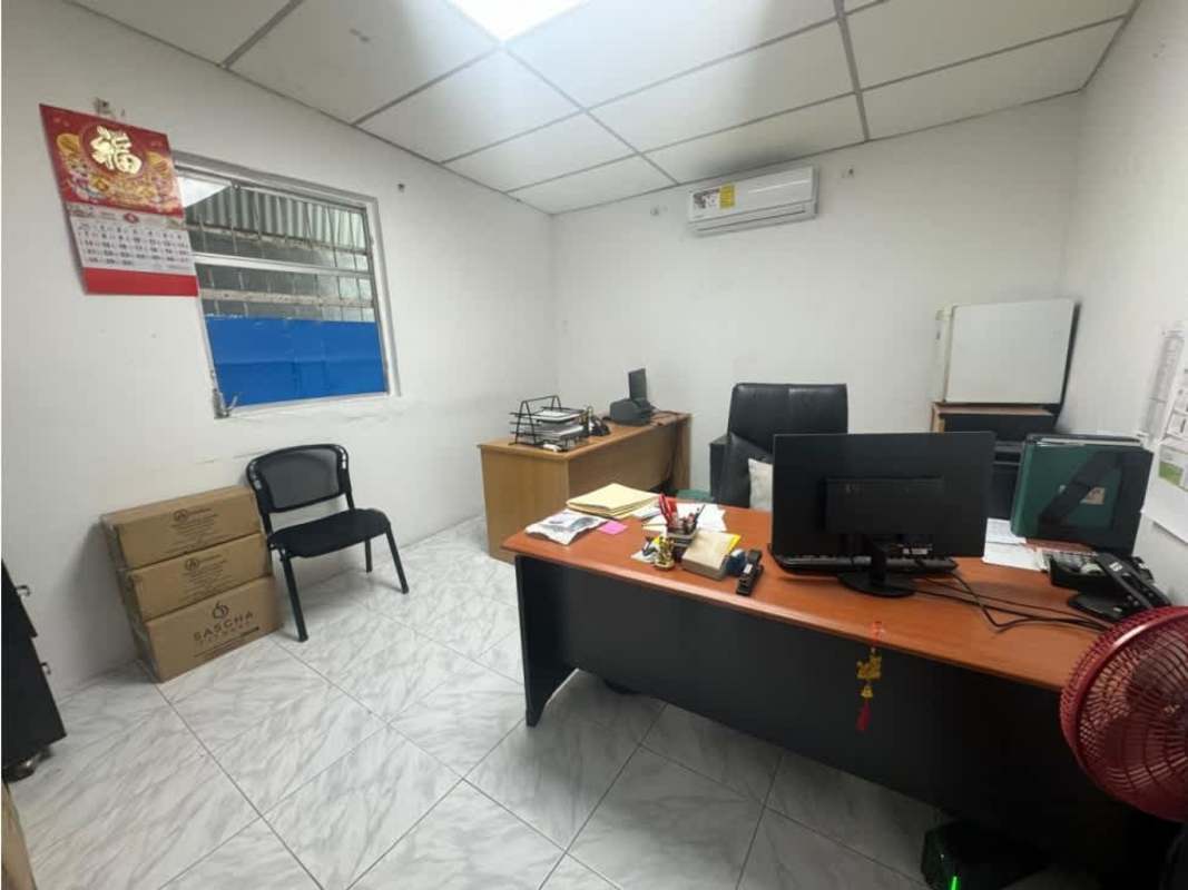 Compact administrative office with desk, AC, and TV in commercial warehouse Llano Bonito Panama