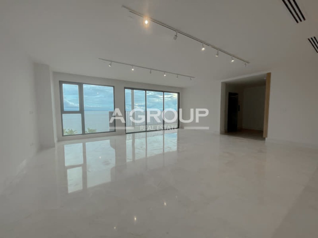 Large open plan living room with balcony and floor-to-ceiling windows Seascape Ocean Reef Islands