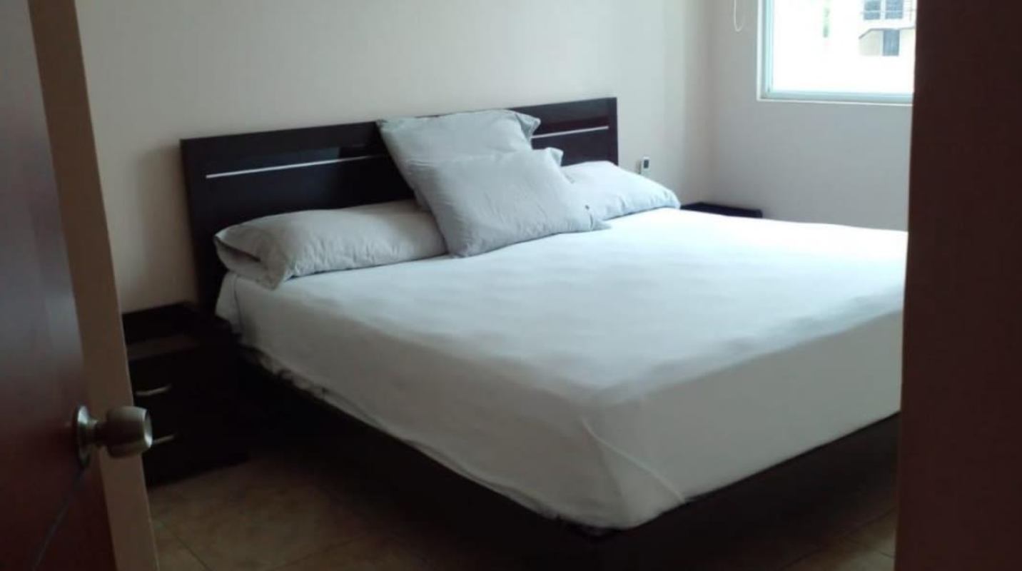 Open plan living dining room with glass table, large window in PH Bella Vista Tower Panama City