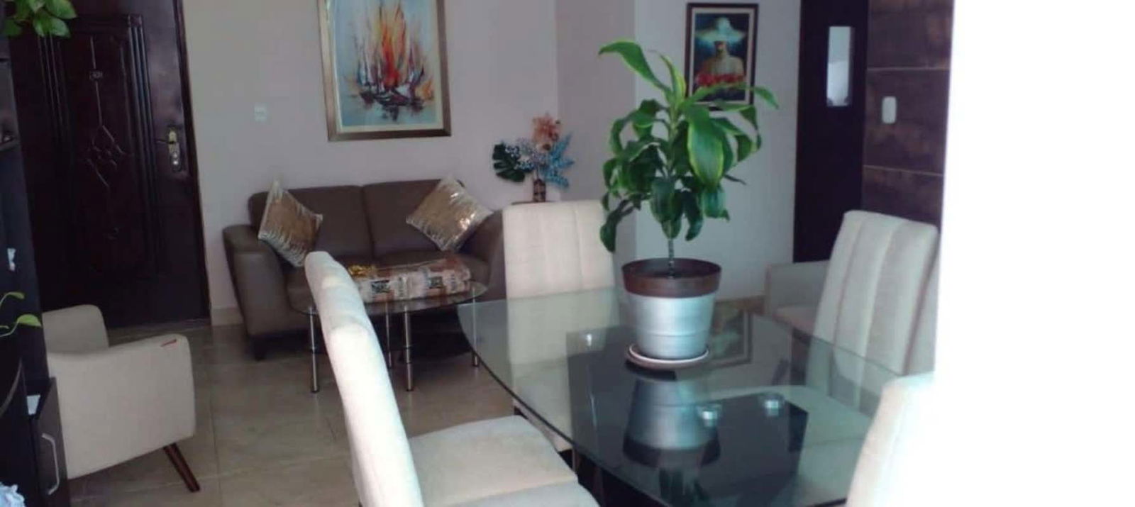 Modern kitchenette with white countertop, microwave, marble-style backsplash at PH Bella Vista Tower Panama