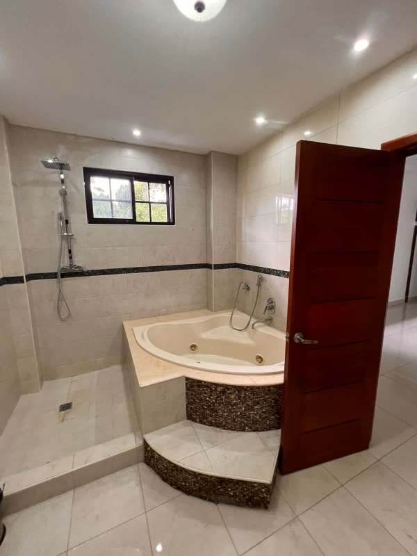 Elegant bathroom with corner jacuzzi tub, walk-in shower, beige tiles Curundu Panama