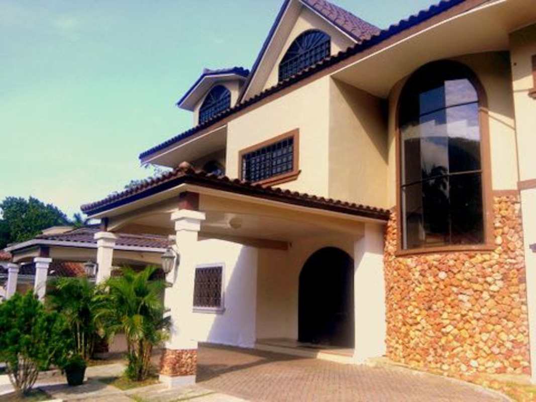 Mediterranean-style mansion with arched windows, tiled roof, lush landscape Curundu Panama