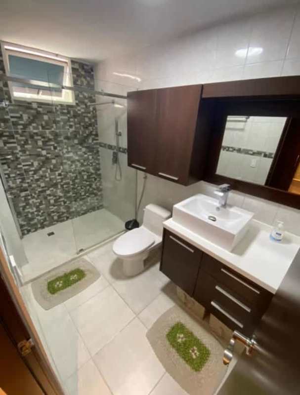 Spacious bedroom with wood furniture ceiling fan in PH Obarrio Central Panama