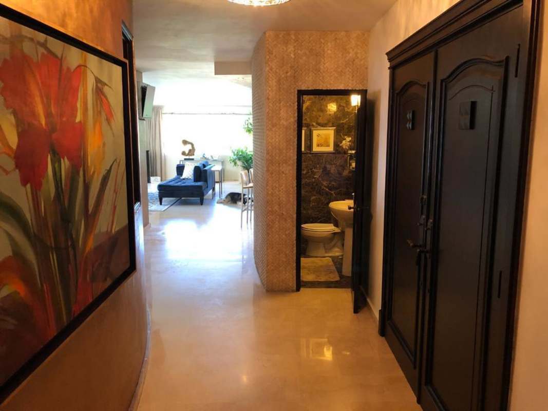 Luxurious living and dining rooms with marble floors and balcony access in PH La Cresta Tower Panama