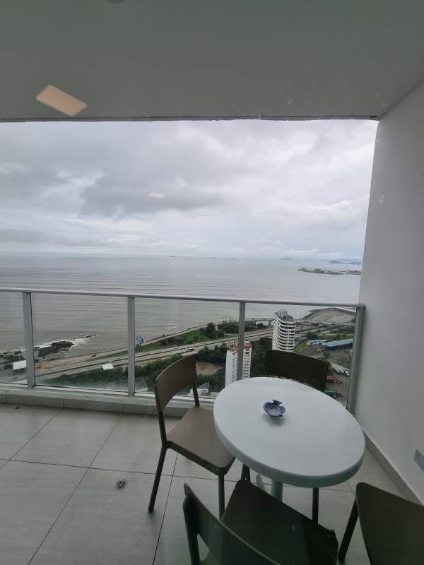 Ocean view furnished bedroom with large window at PH Le Mare in Coco del Mar Panama City