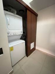 Modern kitchen with island, granite countertops, stainless appliances in PH River Valley Howard Panama Pacifico