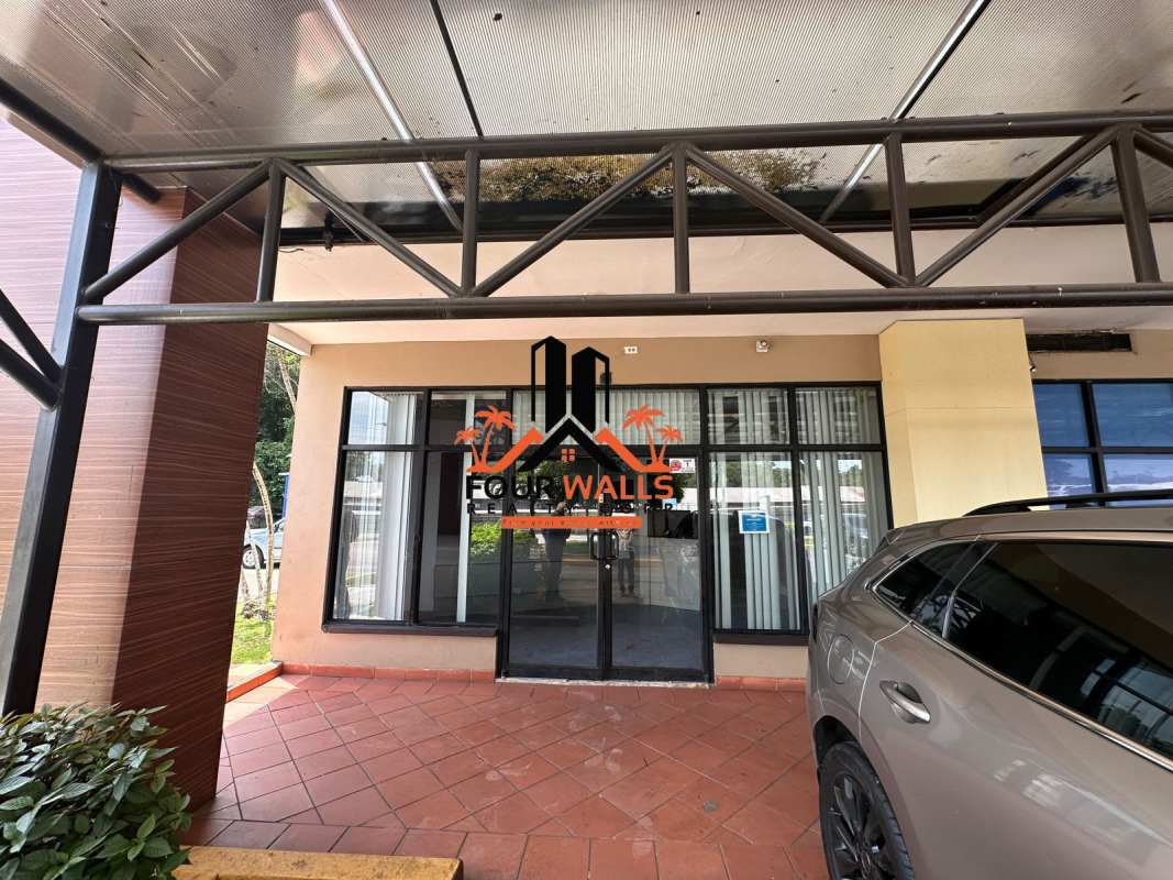 Storefront glass doors, covered walkway, and windows commercial plaza Albrook