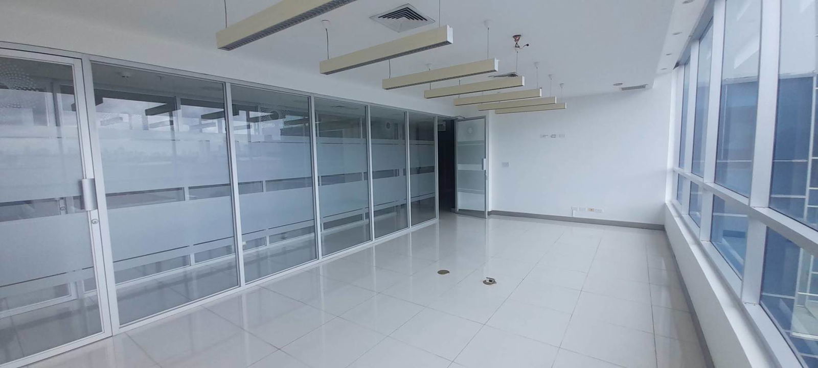 Empty office space with floor-to-ceiling glass partitions in Costa del Este Business Park Panama