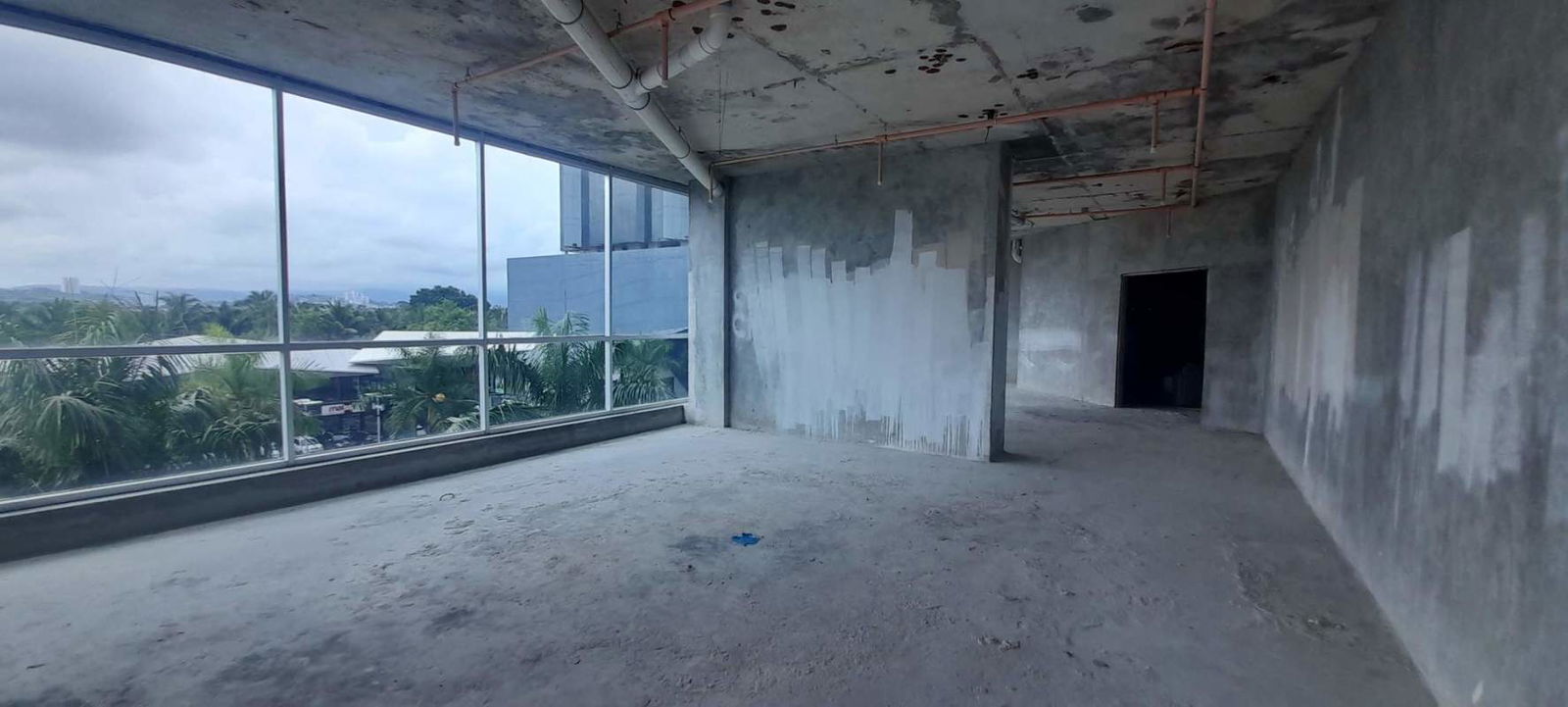 Open unfinished office with floor-to-ceiling windows city view Costa del Este Panama