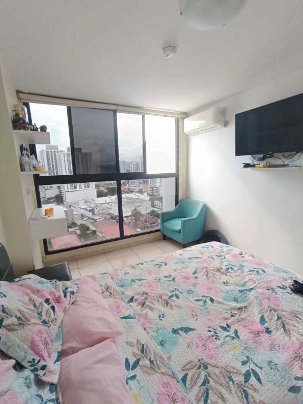 Bright bedroom with large windows and city skyline view PH Vista Verde Panama