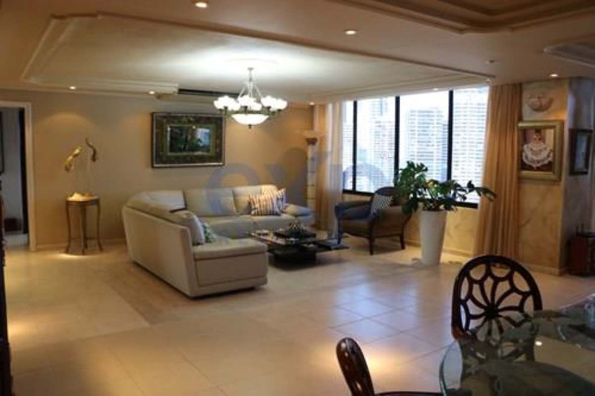 Spacious dining and living area with large windows and chandelier PH Los Jades Panama