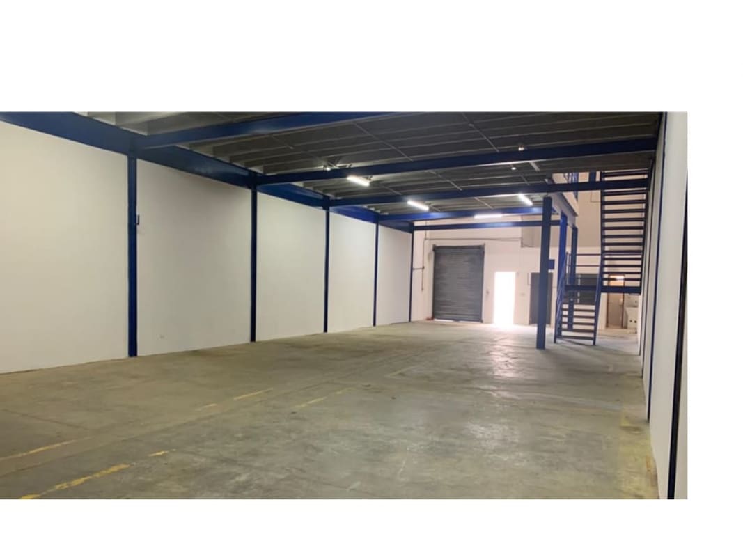 Spacious empty warehouse interior with high ceilings and industrial lighting Llano Bonito Panama