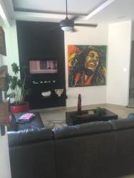 Spacious living room with high ceilings, fan and large windows at Playa Coronado villa