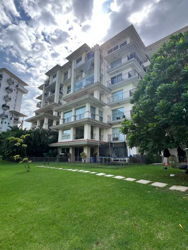 Modern multi-story condo buildings with balconies and landscaped gardens The Reserve Santa Maria Panama