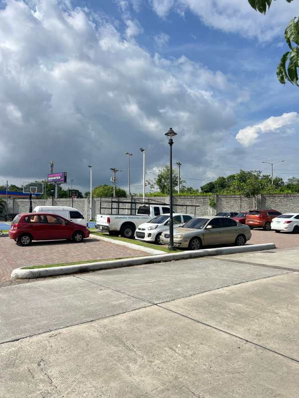 Parking lot with cars adjacent to basketball court and residential buildings at The Reserve Santa Maria