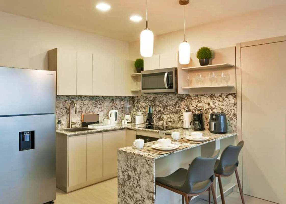 Modern granite kitchen with dining bar stainless appliances in PH Arcadia Costa del Este