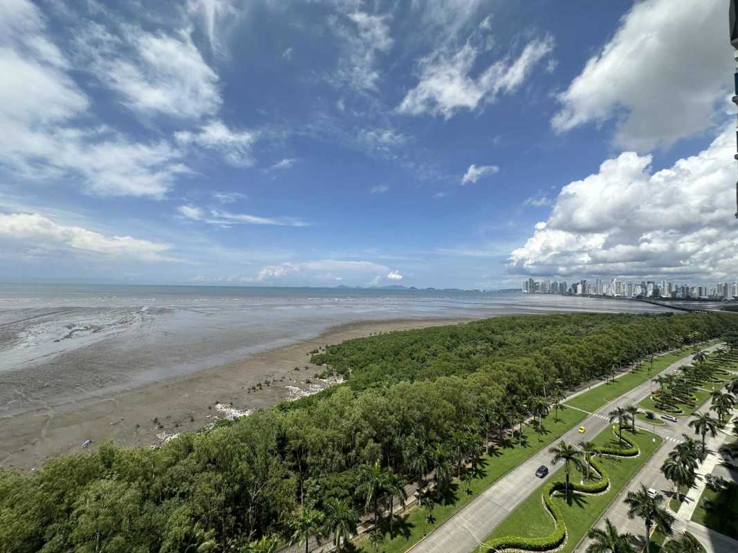 Elegant living and dining room with beige sofas, large entertainment center, wall art in PH Panama Bay Tower Costa del Este Panama