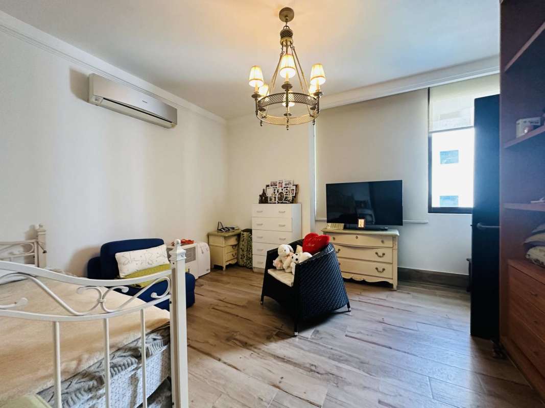 Elegant living room with entertainment center, sofas, wall art PH Panama Bay Tower Costa del Este Panama