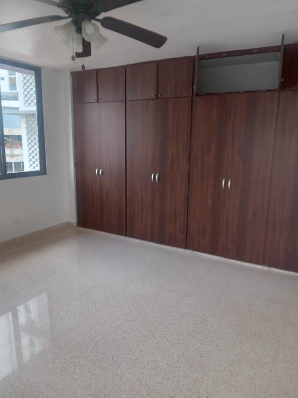 Bedroom with wooden closets, ceiling fan and big windows in PH Arcadia El Cangrejo Panama City