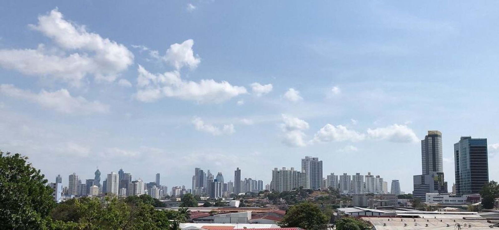 Bright living room with large windows and exposed beams in Villa de las Fuentes house