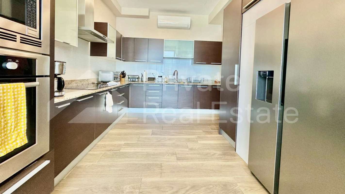 Luxury penthouse kitchen with granite countertops, modern appliances Costa del Este Panama