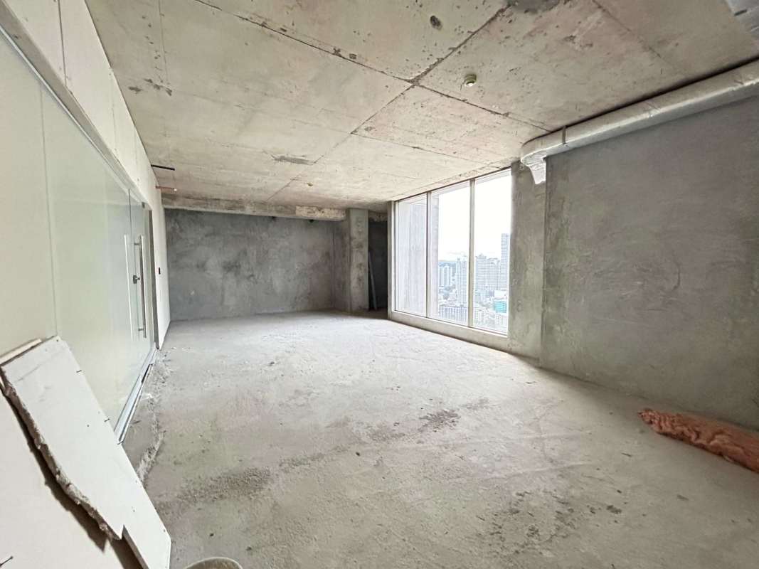 Empty unfinished commercial office space with large windows PH Twist Tower Panama